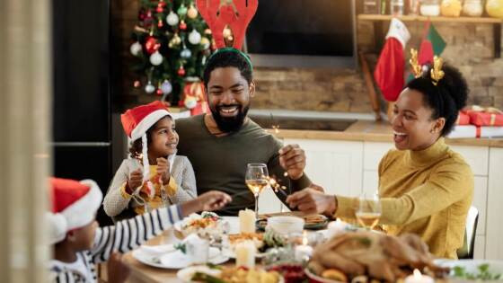 happy-black-family-having-fun-with-sparklers-during-christmas-lunch-picture-id1281847249-1 (1).jpg